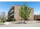 Exterior of apartment complex with mature trees and landscaping at 100 S Clarkson St # 304, Denver, CO 80209