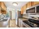 Kitchen with stainless steel appliances and wood cabinets at 100 S Clarkson St # 304, Denver, CO 80209