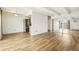 Open-concept living space featuring light wood floors, white walls and ceiling beams at 100 S Clarkson St # 304, Denver, CO 80209