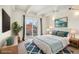 Bright main bedroom featuring a large bed, ceiling fan, and sliding glass door to balcony at 100 S Clarkson St # 304, Denver, CO 80209