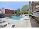 A clear, well-maintained community pool with seating and a fenced perimeter for resident enjoyment at 100 S Clarkson St # 304, Denver, CO 80209