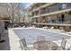 Common space with seasonal community pool and lounge chairs at 100 S Clarkson St # 304, Denver, CO 80209
