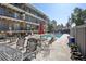 A view of the community pool area, complete with lounge chairs, tables, and a manicured poolside for relaxing at 100 S Clarkson St # 304, Denver, CO 80209