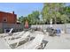 A comfortable community pool and lounge area with tables, chairs, and barbecue grills at 100 S Clarkson St # 304, Denver, CO 80209