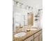 Bathroom with double vanity, granite countertop and a large mirror at 6021 Yarrow St # B12, Arvada, CO 80004