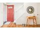 Bright entryway with red door, staircase, and small table at 6021 Yarrow St # B12, Arvada, CO 80004