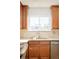 Bright kitchen with a window above the sink and wood cabinets at 6021 Yarrow St # B12, Arvada, CO 80004