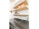 Laundry room with wooden shelves and stylish storage solutions at 6021 Yarrow St # B12, Arvada, CO 80004