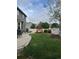 Landscaped backyard with green grass, a seating area, a playset, and a white fence at 5861 Mt Shadows Blvd, Firestone, CO 80504