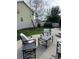 Back yard with an outdoor seating area, green grass, mature trees and a white fence at 5861 Mt Shadows Blvd, Firestone, CO 80504