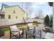 Relaxing backyard featuring patio seating with plush cushions, a manicured lawn, and privacy fencing at 5861 Mt Shadows Blvd, Firestone, CO 80504