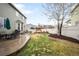 Large backyard with patio, play set, green lawn, and privacy fence, perfect for outdoor activities and enjoyment at 5861 Mt Shadows Blvd, Firestone, CO 80504