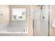 Bright bathroom with a separate shower and bathtub, offering a clean and modern design at 5861 Mt Shadows Blvd, Firestone, CO 80504