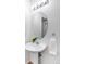 Bathroom featuring a pedestal sink, oval mirror, and white accents at 5861 Mt Shadows Blvd, Firestone, CO 80504