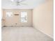 Spacious bedroom with plush carpeting, a ceiling fan, and abundant natural light from the multiple windows at 5861 Mt Shadows Blvd, Firestone, CO 80504