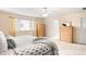 Bright bedroom with ample natural light, hardwood furniture, and a comfortable bed, creating a serene space at 5861 Mt Shadows Blvd, Firestone, CO 80504