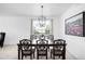 Bright dining room with a wooden table, stylish chairs, and a decorative chandelier at 5861 Mt Shadows Blvd, Firestone, CO 80504