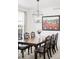 Elegant dining room featuring a dark wood table, decorative chairs, and a modern chandelier at 5861 Mt Shadows Blvd, Firestone, CO 80504