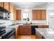 Bright kitchen features wood cabinets and granite countertops at 5861 Mt Shadows Blvd, Firestone, CO 80504
