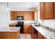 Bright kitchen features wood cabinets, granite countertops, and a large window at 5861 Mt Shadows Blvd, Firestone, CO 80504