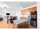 Open concept kitchen features wood floors, granite countertops, stainless appliances at 5861 Mt Shadows Blvd, Firestone, CO 80504