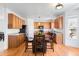 Charming kitchen features wood cabinets, granite countertops, and a cozy dining area for Gathering meals at 5861 Mt Shadows Blvd, Firestone, CO 80504