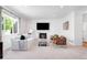 Cozy living room with a fireplace, comfortable seating, and natural light at 5861 Mt Shadows Blvd, Firestone, CO 80504