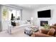 Bright living room with a fireplace, large window, and comfortable seating arrangement at 5861 Mt Shadows Blvd, Firestone, CO 80504