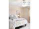 Bright main bedroom boasts neutral paint, comfortable bedding, and a ceiling fan at 5861 Mt Shadows Blvd, Firestone, CO 80504