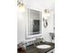 Well lit vanity featuring a stylish mirror and bronze faucet, perfect for a modern bathroom at 9045 W Ithaca Pl, Denver, CO 80235