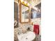 Quaint bathroom with floral wallpaper, vintage fixtures, and a unique vanity with ample lighting at 9045 W Ithaca Pl, Denver, CO 80235
