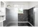 Modern bathroom with a glass-enclosed shower and stylish tile accents at 9045 W Ithaca Pl, Denver, CO 80235