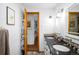Bathroom with dual sinks, granite countertops, and modern fixtures at 9045 W Ithaca Pl, Denver, CO 80235