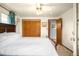 Cozy bedroom features hardwood floors and a spacious closet at 9045 W Ithaca Pl, Denver, CO 80235