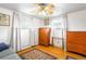 A charming bedroom, filled with natural light, hardwood flooring, and wooden accents at 9045 W Ithaca Pl, Denver, CO 80235