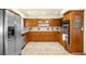 Well-maintained kitchen with wood cabinets, stainless steel appliances, and ample counter space at 9045 W Ithaca Pl, Denver, CO 80235