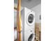 Efficient laundry area with a stacked washer and dryer, maximizing space in a compact area at 9045 W Ithaca Pl, Denver, CO 80235