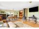 Open-concept living room featuring a fireplace and seamless flow to the dining area at 9045 W Ithaca Pl, Denver, CO 80235