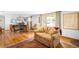 Bright and airy living room with a large picture window, hardwood floors, and a comfortable sofa at 9045 W Ithaca Pl, Denver, CO 80235