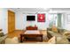 Spacious basement living room featuring comfortable seating, hockey memorabilia, and natural light at 9045 W Ithaca Pl, Denver, CO 80235