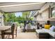 Covered patio featuring comfortable seating, outdoor dining space, and a view of the landscaped backyard at 9045 W Ithaca Pl, Denver, CO 80235