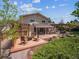 Spacious backyard featuring a deck with firepit, outdoor kitchen, dining area, and a charming water feature at 3138 E Otero Cir, Centennial, CO 80122