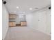 Finished basement with cabinets, recessed lighting, and neutral carpeting perfect for entertaining at 3138 E Otero Cir, Centennial, CO 80122