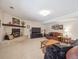 Relaxing basement featuring brick fireplace, leather seating, and carpeted floors at 3138 E Otero Cir, Centennial, CO 80122