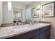 Bathroom featuring double sinks with granite counters and decorative framed mirror at 3138 E Otero Cir, Centennial, CO 80122