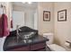 Elegant powder room featuring a vessel sink, stylish fixtures, and tasteful wall decor at 3138 E Otero Cir, Centennial, CO 80122