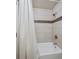 Bright bathroom with white tiled bathtub and shower combination, along with modern fixtures at 3138 E Otero Cir, Centennial, CO 80122