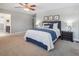 Bright primary bedroom suite featuring a queen bed, nightstands, and ensuite bathroom entrance at 3138 E Otero Cir, Centennial, CO 80122