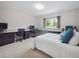 Bright bedroom featuring a built-in desk area and a window that offers a view of the outdoors at 3138 E Otero Cir, Centennial, CO 80122