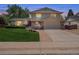 Charming home with a well-manicured lawn, walkway and attached two car garage at dusk at 3138 E Otero Cir, Centennial, CO 80122